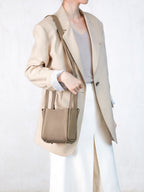 Songmont Small Song Bag Cream Apricot - worn with the shoulder strap