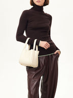 Songmont Small Song Bag Ivory - held at the hip by the top handles