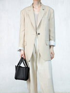 Songmont Small Song Bag Onyx - carried by the top handles