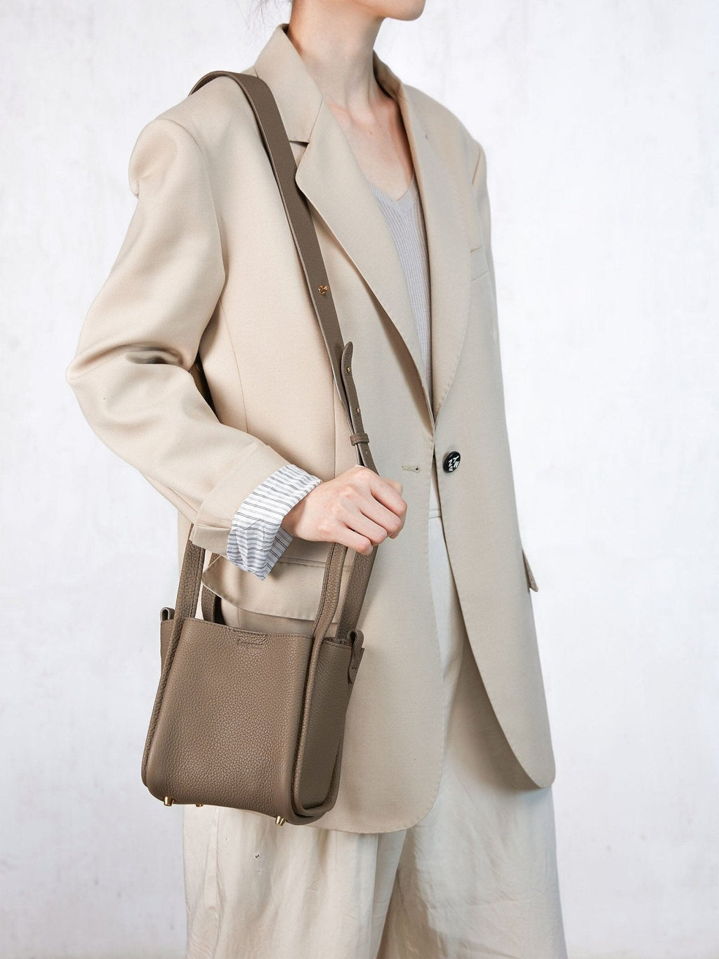 Songmont Small Song Bag Taupe - worn with the shoulder strap