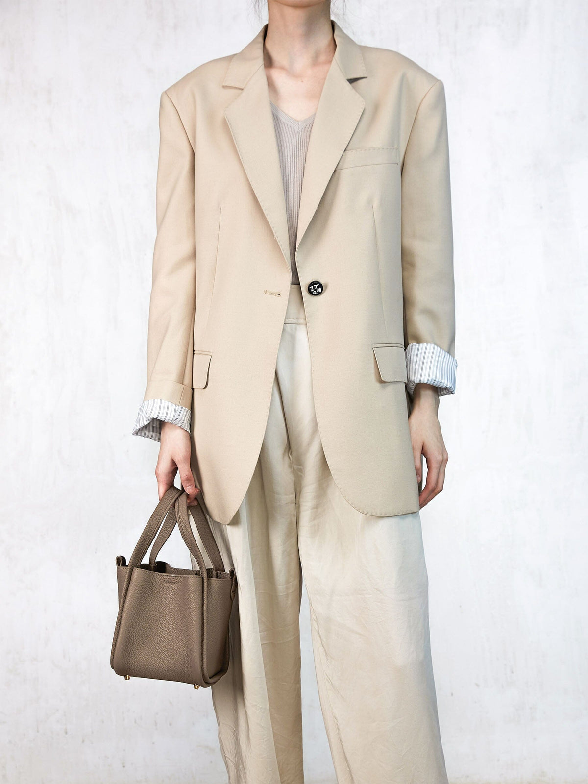 Songmont Small Song Bag Taupe - carried by the top handles