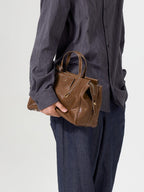 Songmont Small Yore Duffle Bag Sandal - held at the side by the top handles
