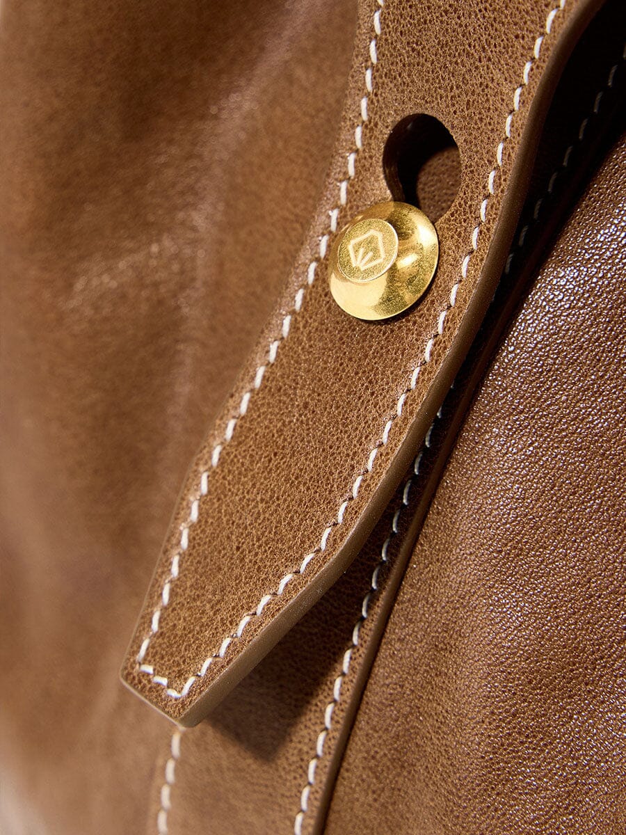 Songmont Small Yore Duffle Bag Sandal - close-up of gold stud and white stitching