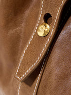 Songmont Small Yore Duffle Bag Sandal - close-up of gold stud and white stitching
