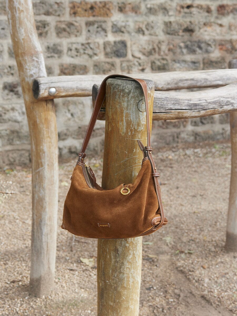 Songmont Small Yore Hobo Bag (Minimal Version) Sandal Suede - hanging from a wooden post