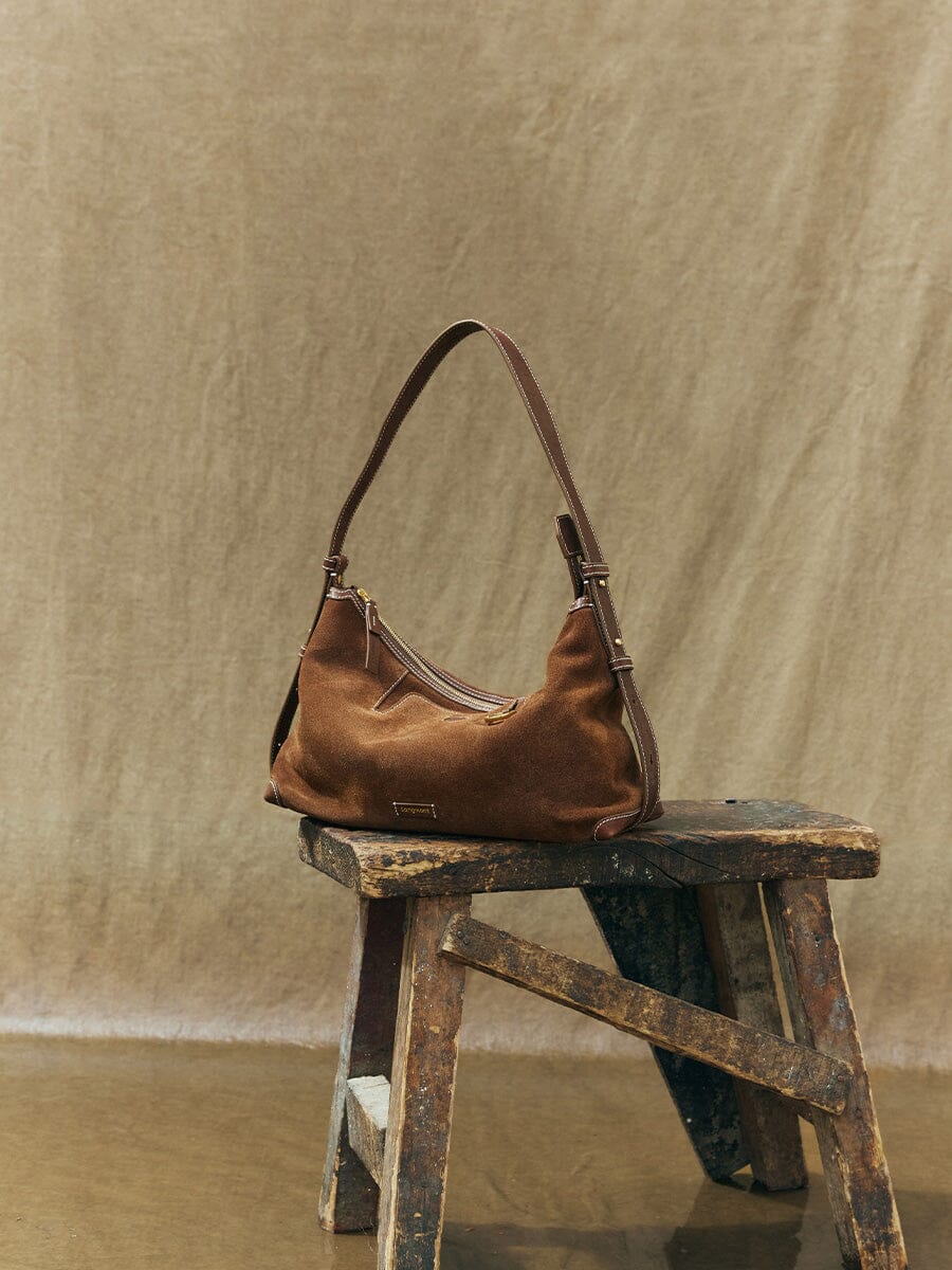 Songmont Small Yore Hobo Bag (Minimal Version) Sandal Suede - on a wooden stool