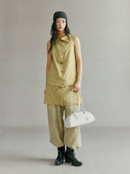 Songmont Small Yore Toast Bag Cloud - carried by the straps with an olive linen outfit
