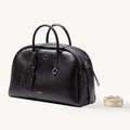 Songmont Large Yore Bowling Bag Ebony - front three-quarter view with woven strap