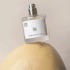 TO SUMMER Pomelo Eau de Parfum spray bottle on a pomelo