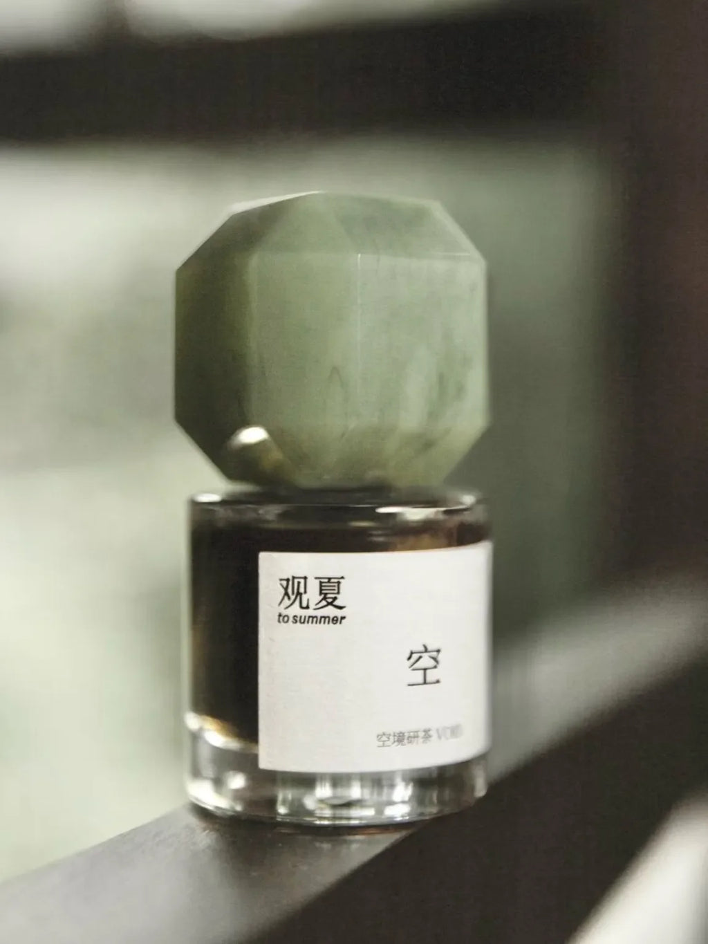 TO SUMMER Void Eau de Parfum octagon jade cap bottle on a windowsill