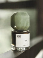 TO SUMMER Void Eau de Parfum octagon jade cap bottle on a windowsill