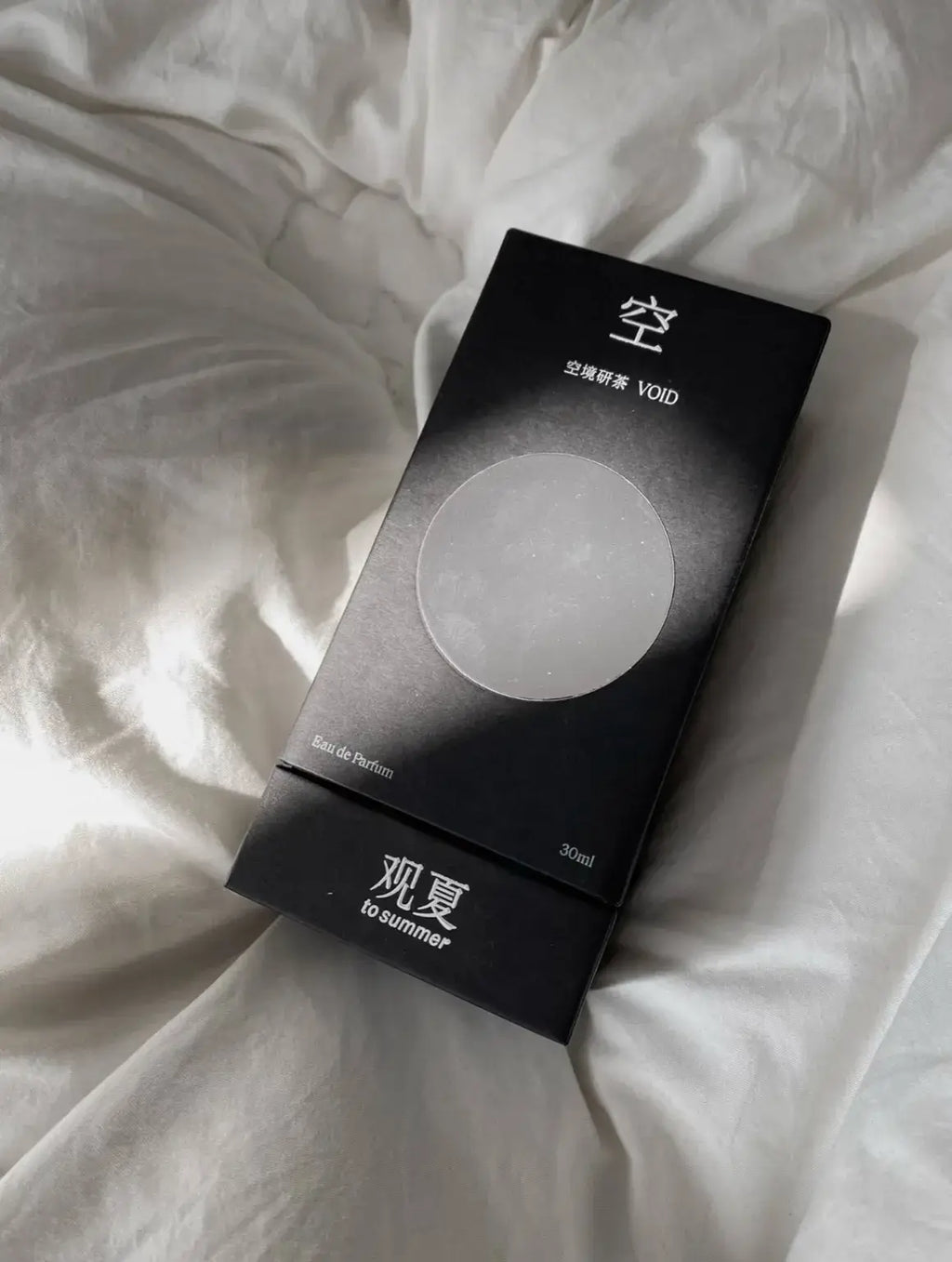 TO SUMMER Void Eau de Parfum black gift box on white linen