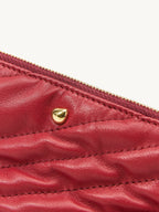 Songmont Winding Underarm Bag Lucky Red - close-up of diagonal quilting and gold stud