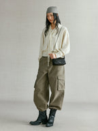 Songmont Winding Underarm Bag Onyx - full-length styling with cream knit and boots