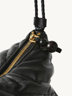 Songmont Winding Underarm Bag Onyx - braided strap, gold zip and dark bead pull