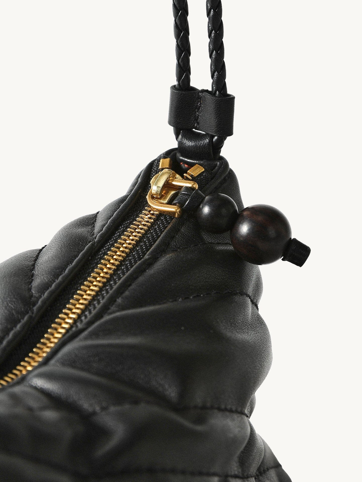 Songmont Winding Underarm Bag Onyx - braided strap, gold zip and dark bead pull