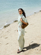 Songmont Yore Baguette Bag Sandal worn on the shoulder at the beach
