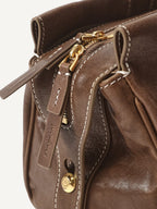 Songmont Yore Baguette Bag Sandal zipper and logo tag detail