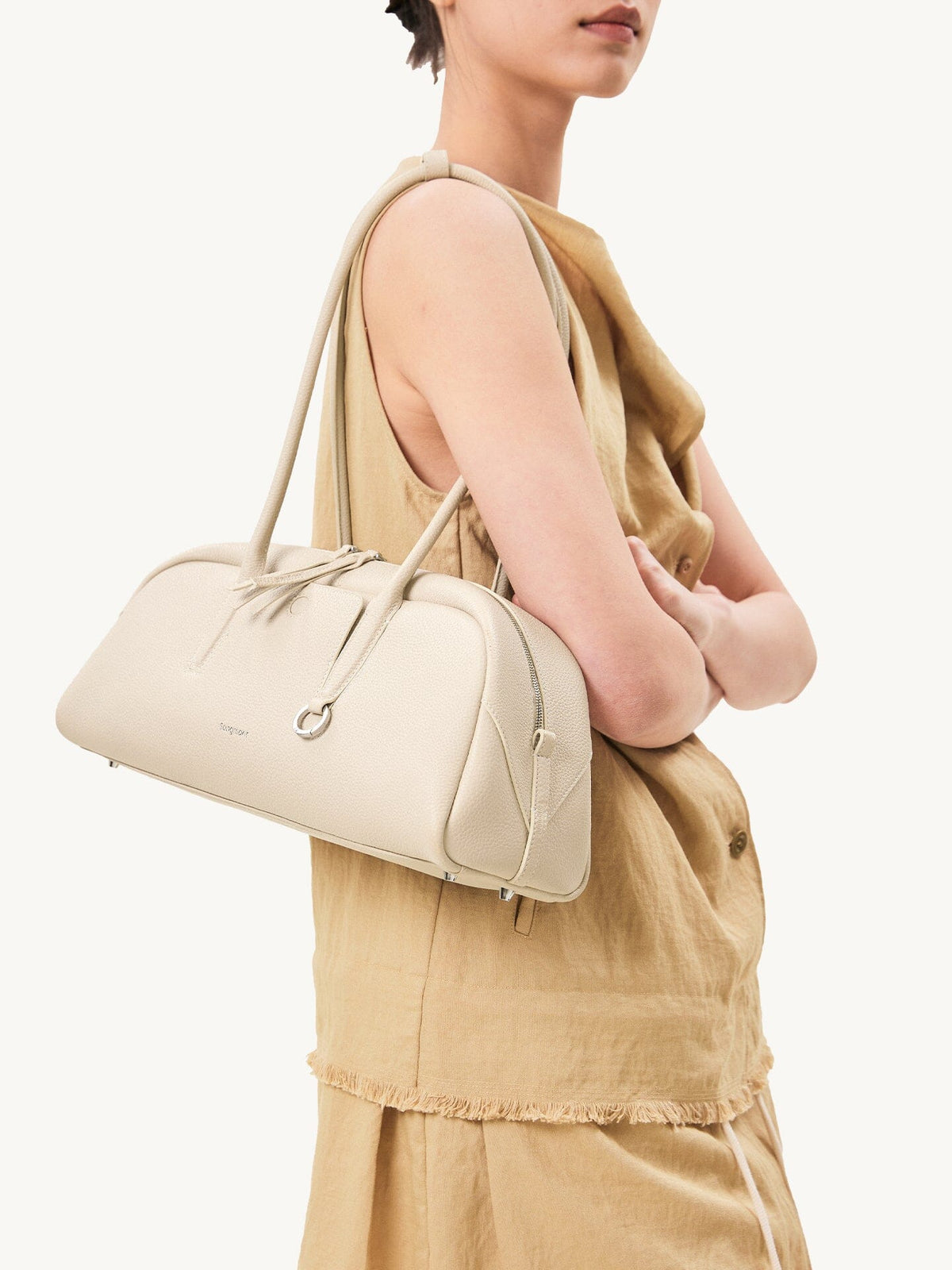 Songmont Yore Toast Bag Cloud - worn on the shoulder with a linen outfit