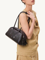 Songmont Yore Toast Bag Ebony - worn on the shoulder with a linen outfit